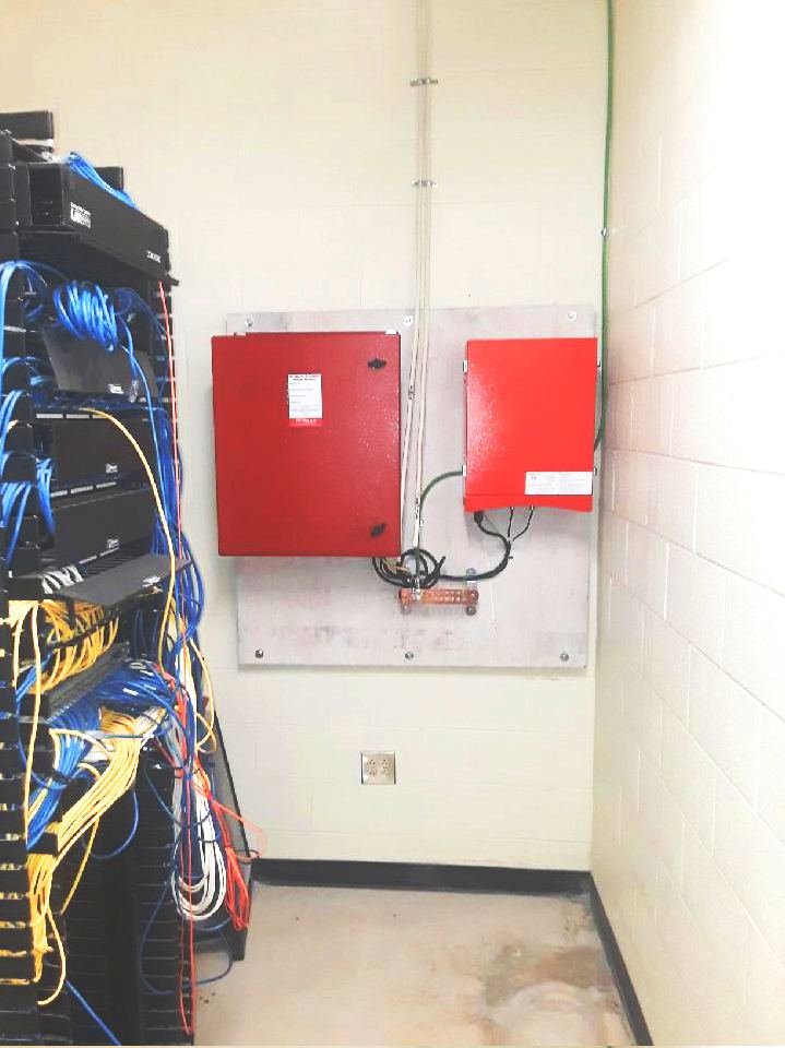 Yellow fiber optic runs dressed into a Lynx equipment rack
